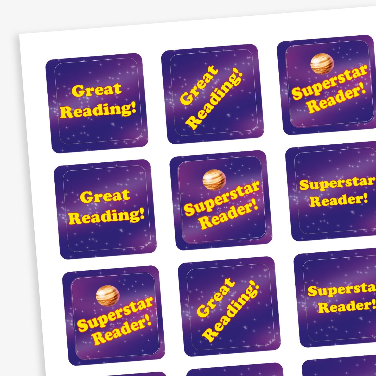 A sheet of square reward stickers with phrases including 'Superstar Reader!' and 'Great Reading!' in yellow text. Each sticker features a purple space themed background.