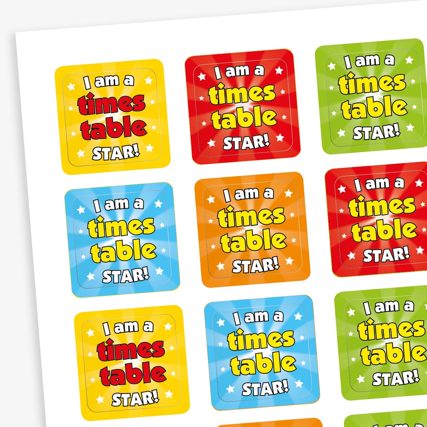 A sheet of square stickers each with the phrase 'I am a times table STAR!' in starburst backgrounds with emissions of small stars in yellow, red, orange, green and blue.