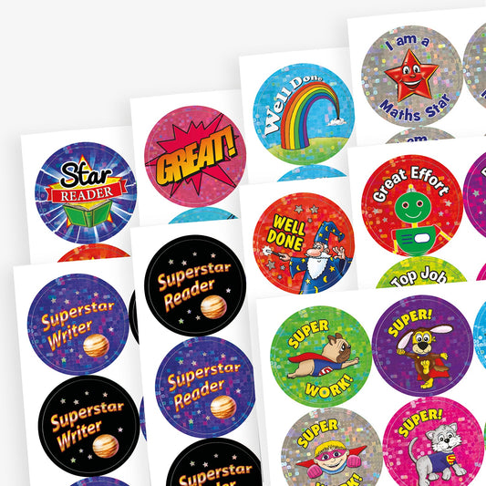 Selection of holographic stickers including 'Superstar Reader' and 'Superstar Writer' against solar backgrounds; superhero animals saying 'Super'. Stars on a silver background saying 'I am a Maths Star' and various other praise stickers.