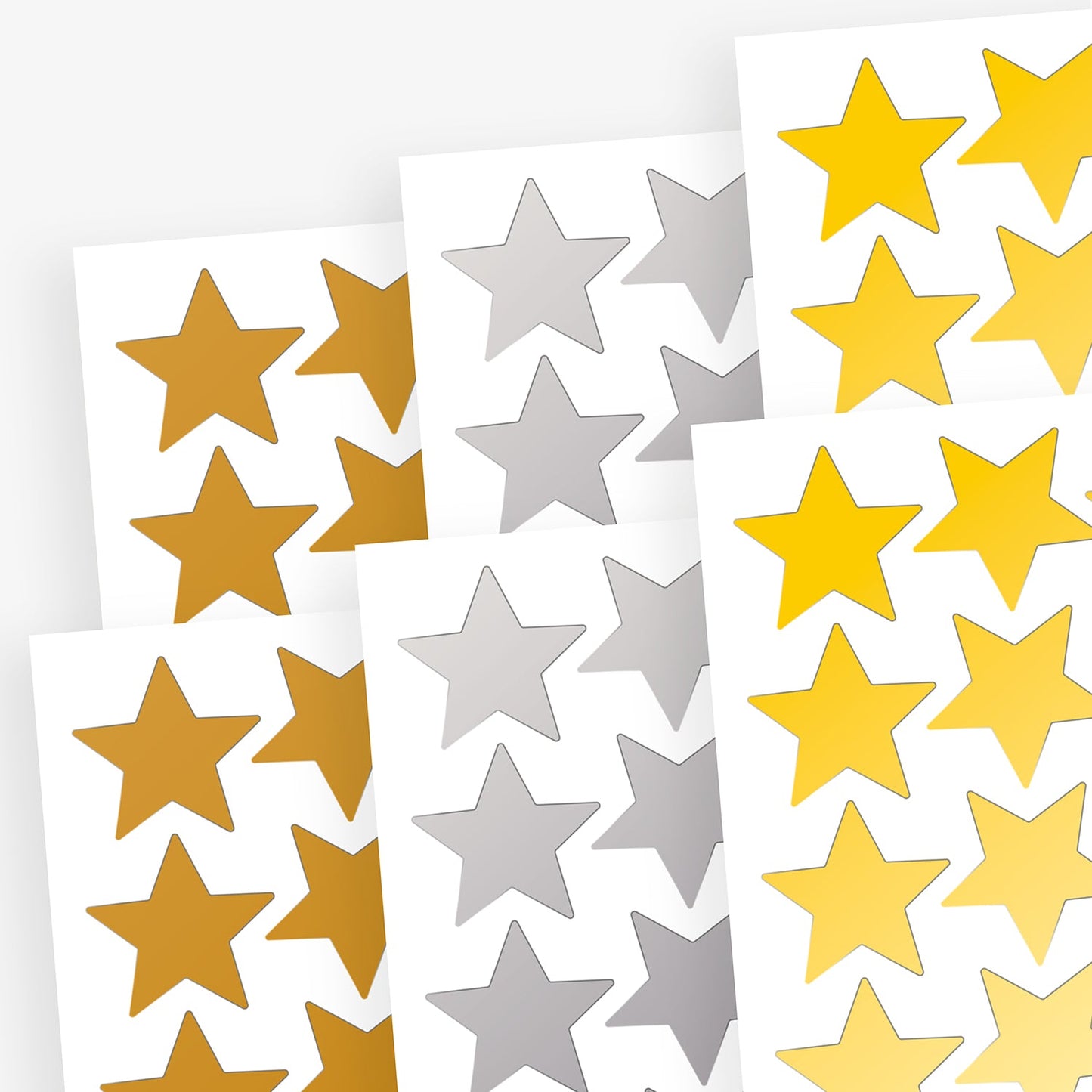 Sheets of gold, silver and bronze star shaped stickers layered upon each other.  Stickers have a metallic finish.