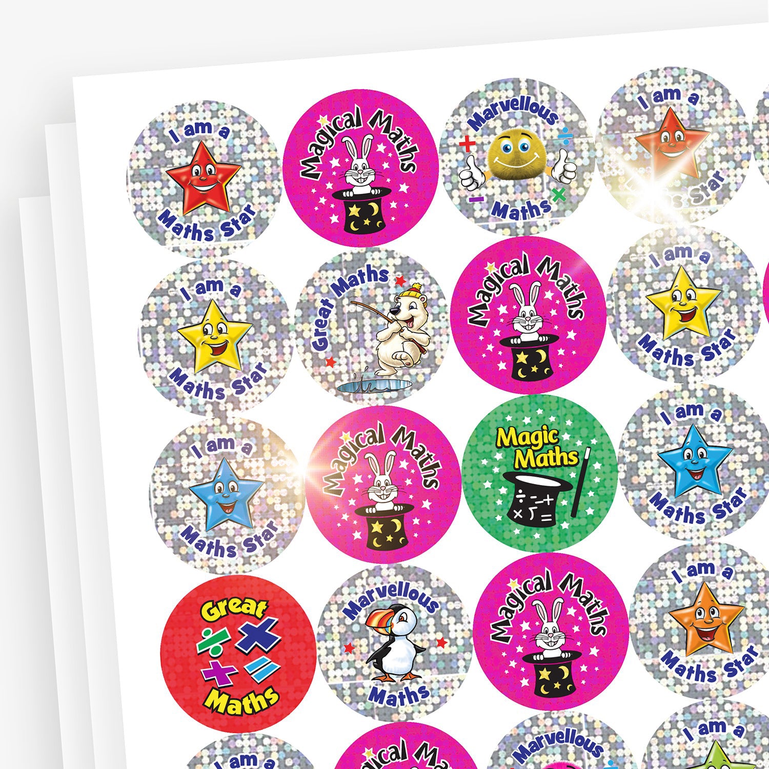 A sheet of sparkly circular reward stickers with the phrase 'I am a Maths Star' in blue and purple text. Each sticker features a smiling cartoon star character in various colours—red, green, blue, orange, and pink—set against a silver holographic background.