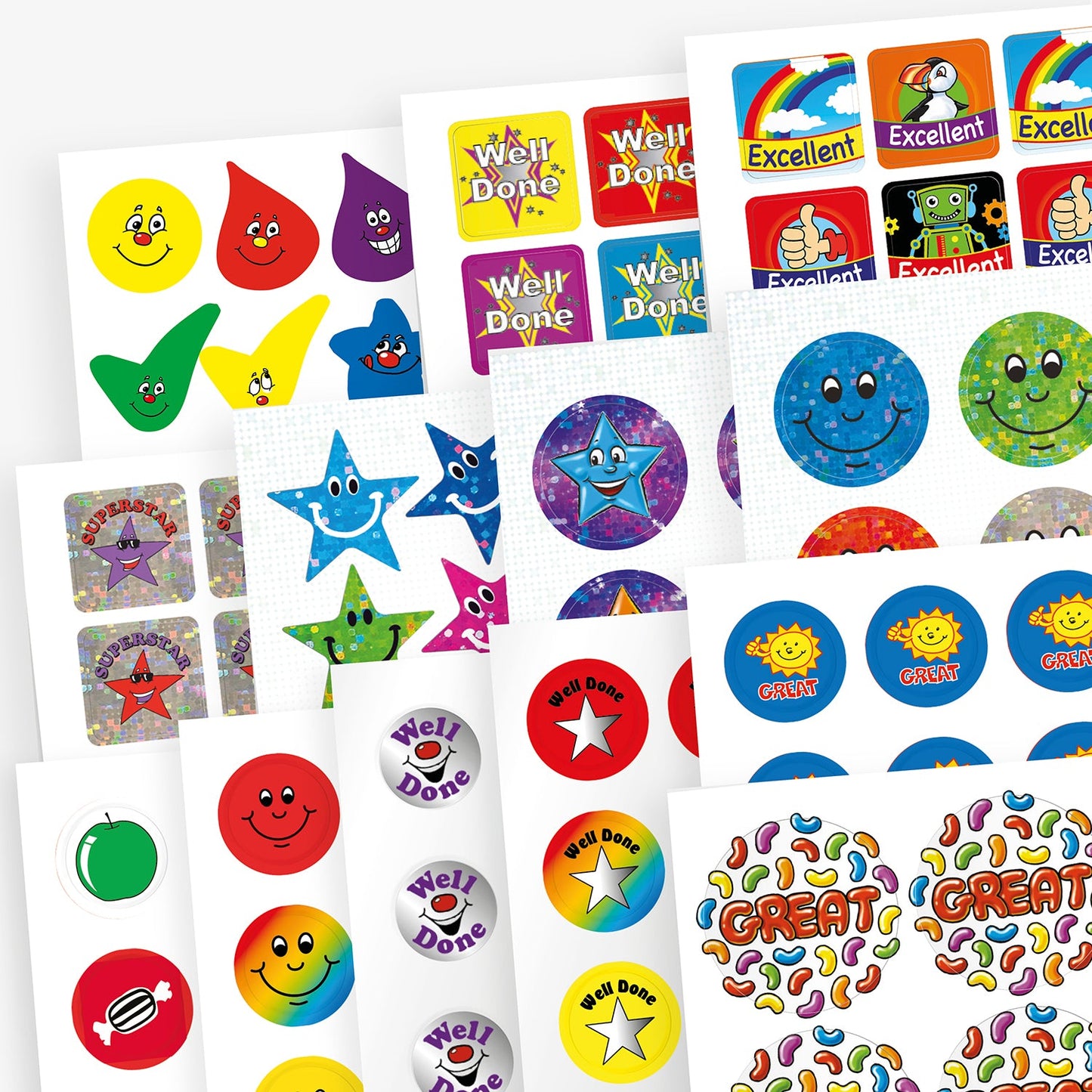 Variety pack of colourful reward stickers featuring cheerful designs such as smiley faces, stars, droplets, cartoon suns, and phrases like 'Well Done', 'Excellent', and 'Great', displayed on multiple sticker sheets.