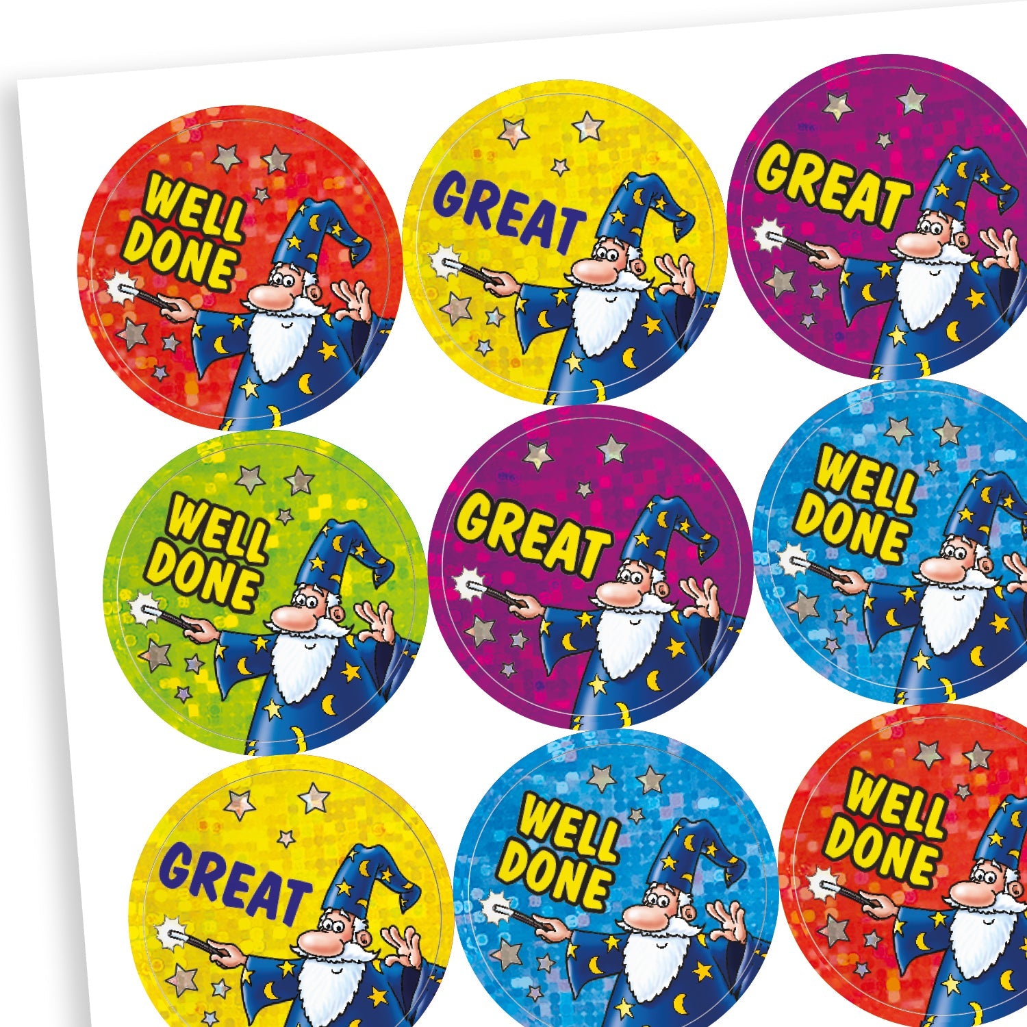 A sheet of colourful circular, holographic reward stickers featuring a cartoon wizard in a blue robe and hat with stars. The stickers display the words 'WELL DONE' or 'GREAT' in bold yellow text. Each has a sparkly background in bright colours such as red, yellow, green, blue, and purple, adding a magical feel.
