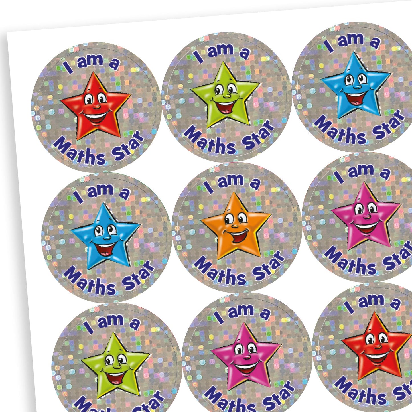 A sheet of sparkly circular reward stickers with the phrase 'I am a Maths Star' in blue and purple text. Each sticker features a smiling cartoon star character in various colours—red, green, blue, orange, and pink—set against a silver holographic background.