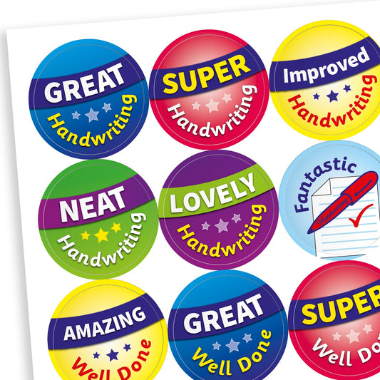 A sheet of brightly coloured circular reward stickers, each featuring positive feedback for handwriting and achievement. Phrases include: 'GREAT Handwriting', 'SUPER Handwriting', 'Improved Handwriting', 'NEAT Handwriting', 'LOVELY Handwriting', 'Fantastic' with a pen and paper icon, 'AMAZING Well Done', 'GREAT Well Done', and 'SUPER Well Done'. Stickers have vibrant backgrounds in blue, red, green, yellow, and purple with stars.