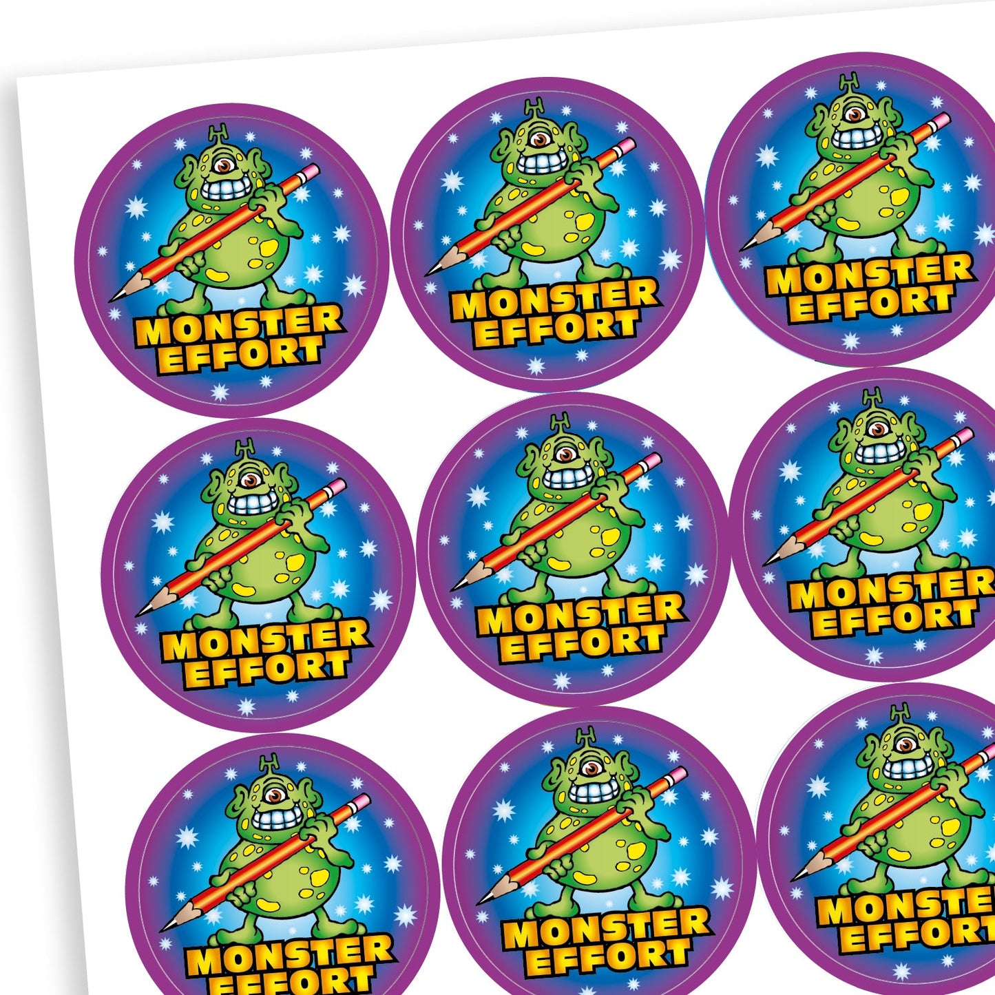 A sheet of circular reward stickers with the phrase 'MONSTER EFFORT' in bold yellow text. Each sticker features a green cartoon monster with purple spots, holding a giant pencil. The background is dark blue with stars, and the border is bright purple.