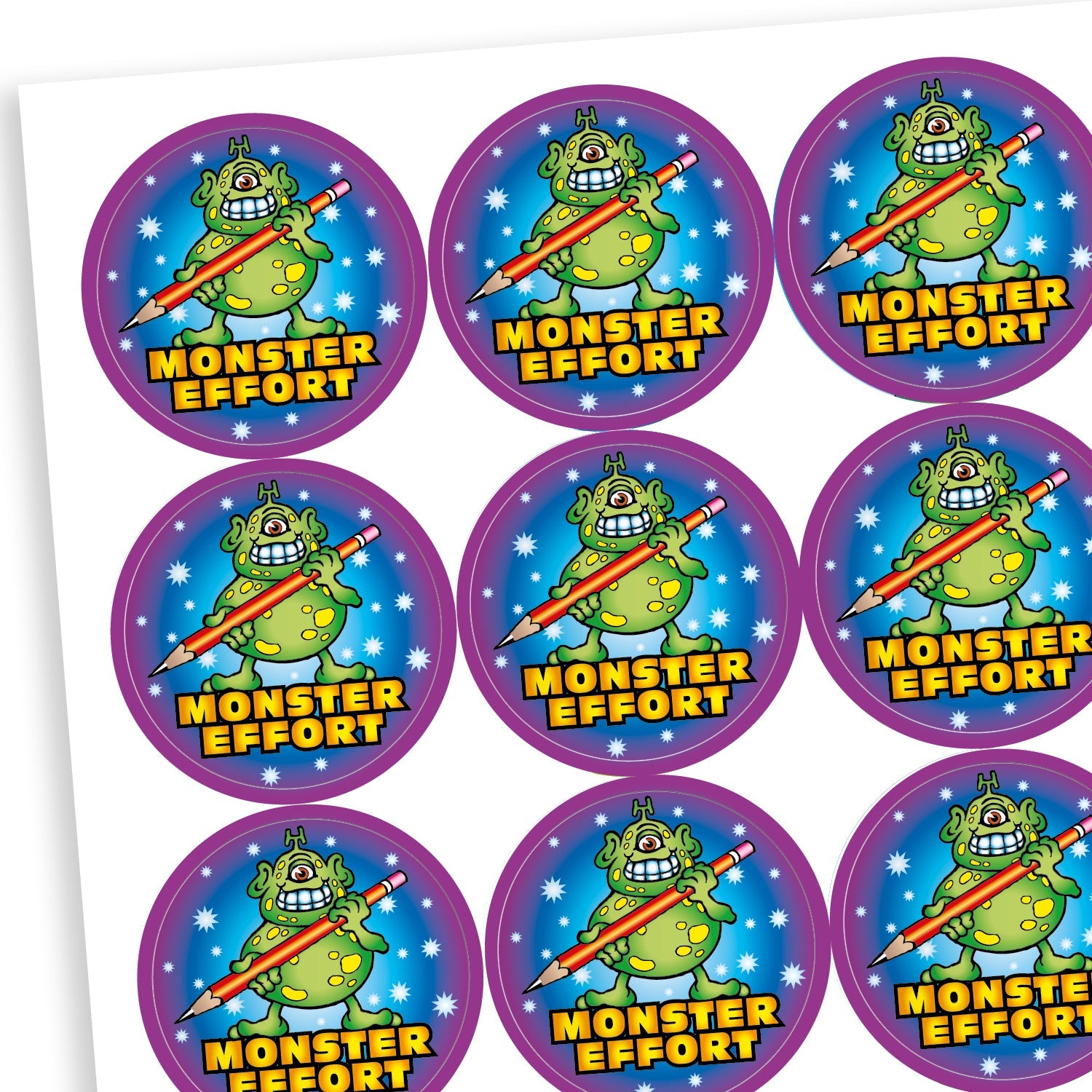 A sheet of circular reward stickers with the phrase 'MONSTER EFFORT' in bold yellow text. Each sticker features a green cartoon monster with purple spots, holding a giant pencil. The background is dark blue with stars, and the border is bright purple.
