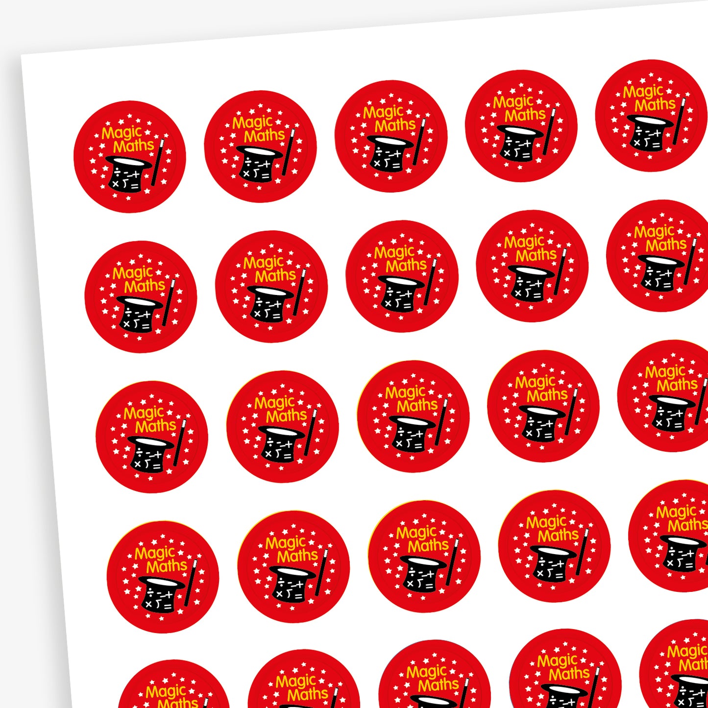 Sheet of 196 assorted 10mm circular reward stickers featuring a magicians hat and wand with mathematical icons and stars on a red background.  Each sticker has the phrase 'Magic Maths' above the hat in yellow text. Each sticker is designed to motivate and reward pupils, suitable for use on charts, books, and clothing.