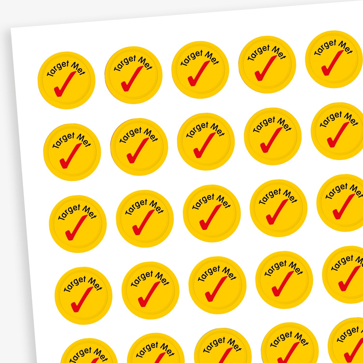 Sheet of 196 assorted 10mm circular reward stickers featuring large red tick icon on a yellow background, each sticker has the phrase 'Target Met' above the tick. Each sticker is designed to motivate and reward pupils, suitable for use on charts, books, and clothing.