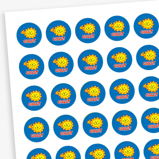 Sheet of 196 assorted 10mm circular reward stickers featuring a smiling yellow sun giving a thumbs up on a blue background, each sticker has the word 'Great' underneath the sun. Each sticker is designed to motivate and reward pupils, suitable for use on charts, books, and clothing.