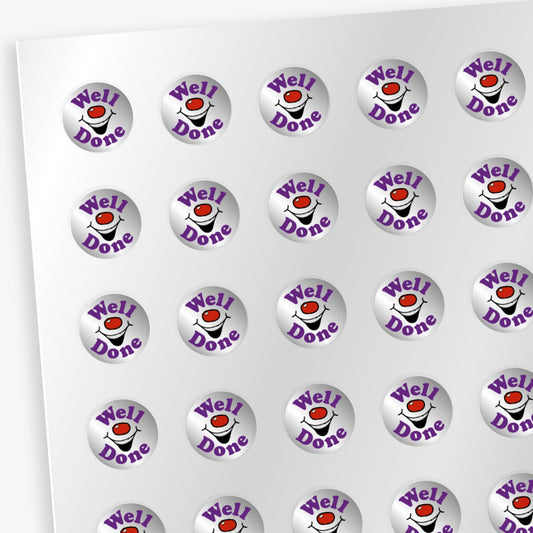 Sheet of 196 metallic 10mm circular silver reward stickers, each with a central red nose and smiling mouth with the word 'Well' in bold purple lettering above the image and 'Done' below the image. The stickers have a shiny, reflective finish and are designed to motivate and reward pupils' achievements.