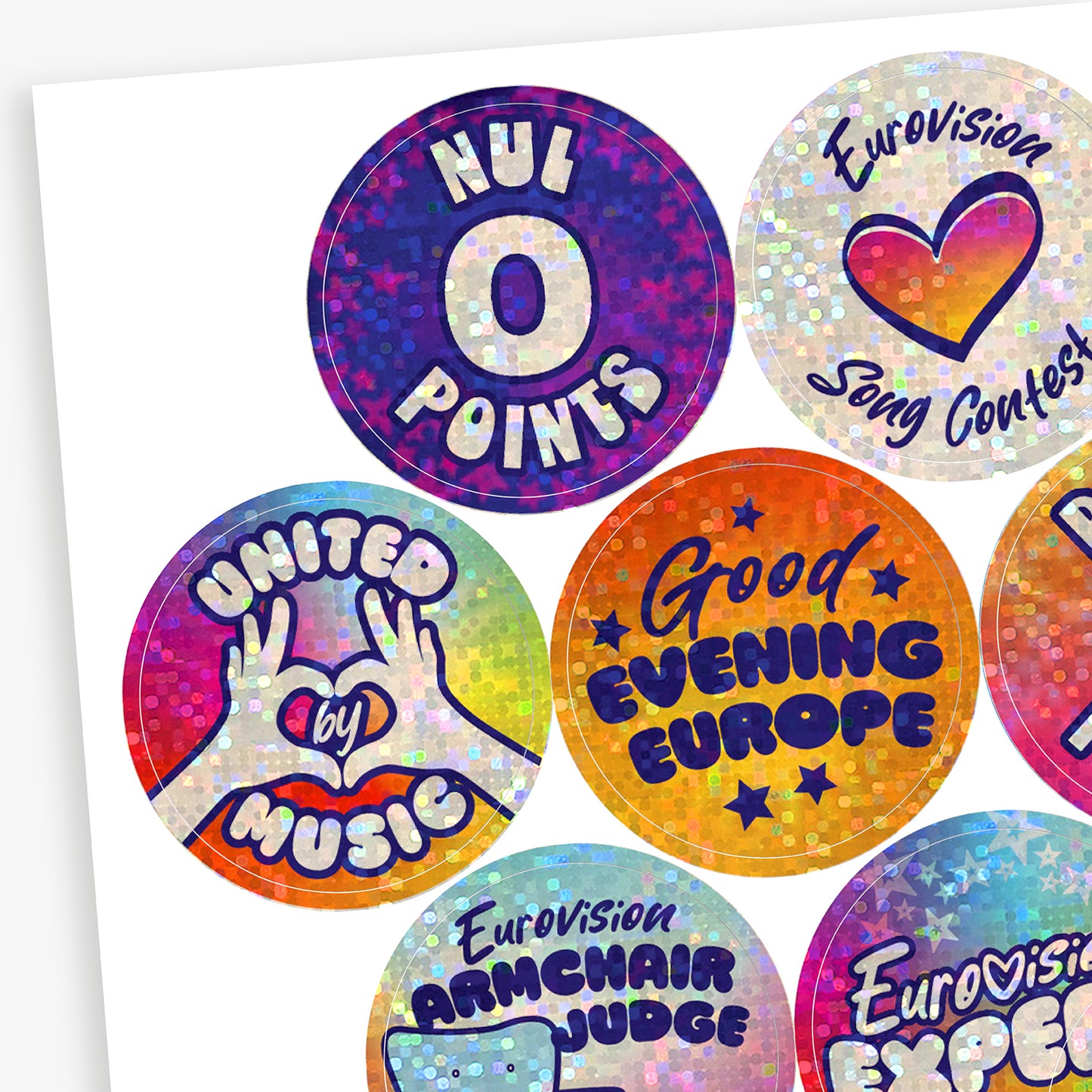 A collection of colourful holographic Eurovision stickers with various texts and designs, including hearts and musical symbols.