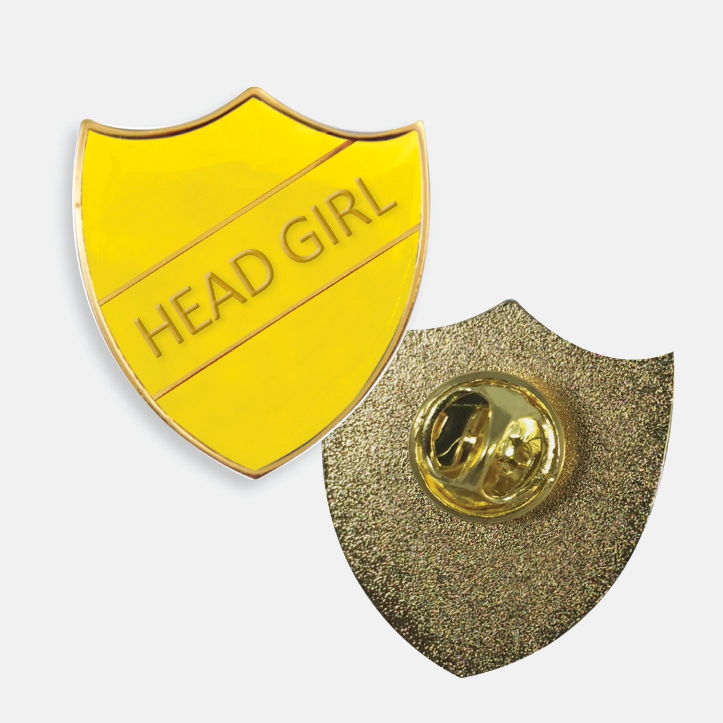 Yellow enamel badge in the shape of a shield with gold trim and diagonal gold line either side of the words 'HEAD GIRL' in capital letters. The reverse side shows a textured gold back with a pin fastening