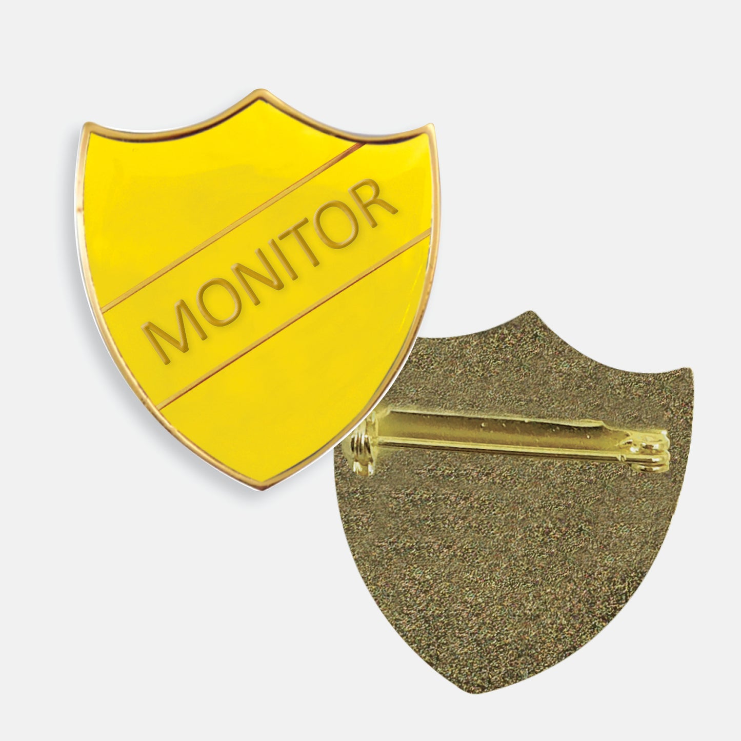 Yellow enamel badge in the shape of a shield with gold trim and diagonal gold line either side of the word 'MONITOR' in capital letters. The reverse side shows a textured gold back with a pin fastening