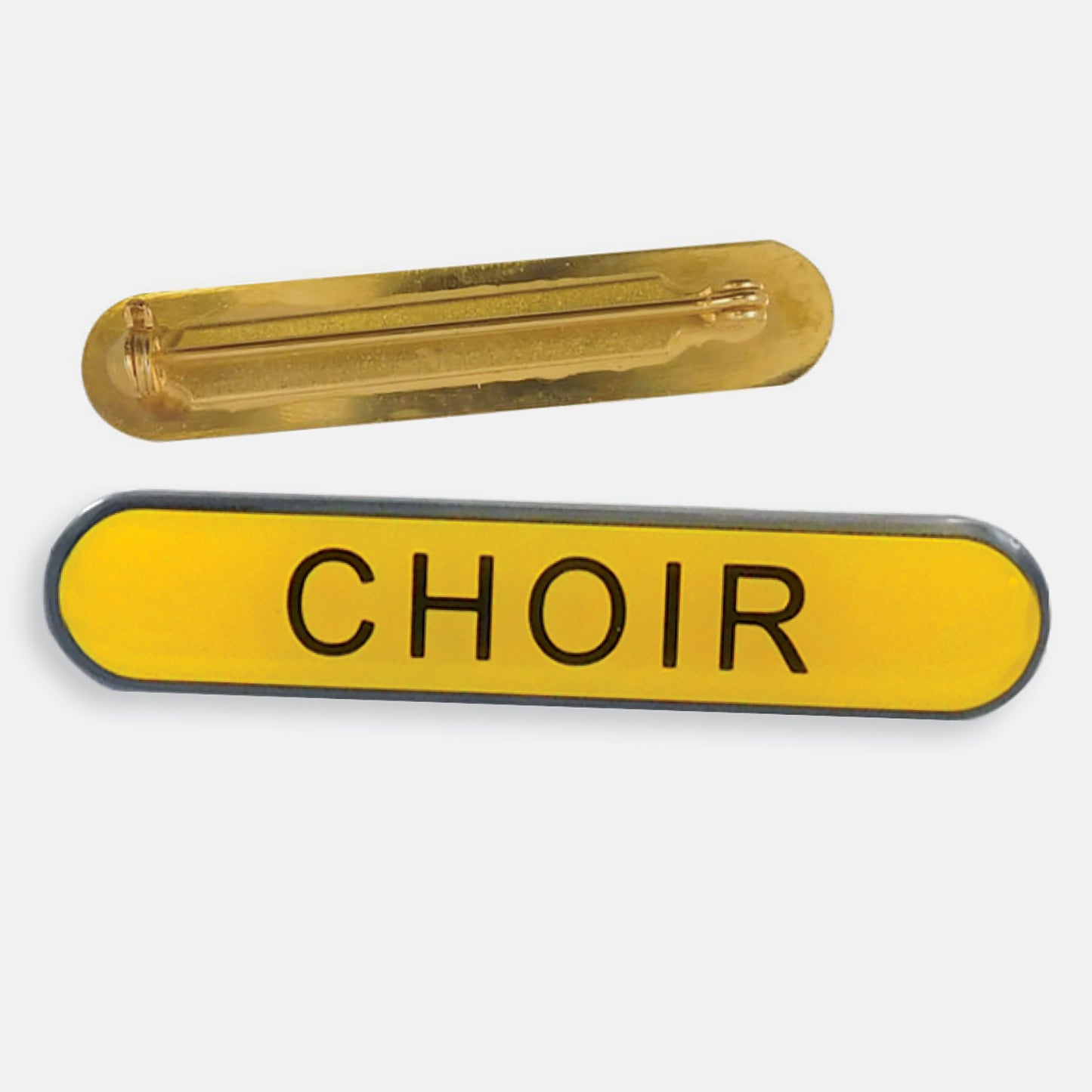 Yellow enamel badge in a long oval shape with the word 'CHOIR' central in black capital letters. The reverse side shows a gold back with a pin fastening
