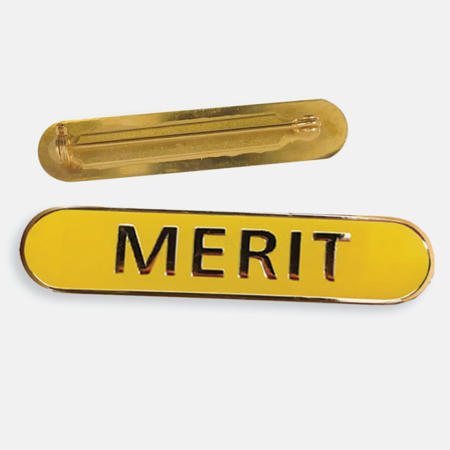 Yellow enamel badge in a long oval shape with a gold trim and the word 'MERIT' central in gold capital letters. The reverse side shows a gold back with a pin fastening