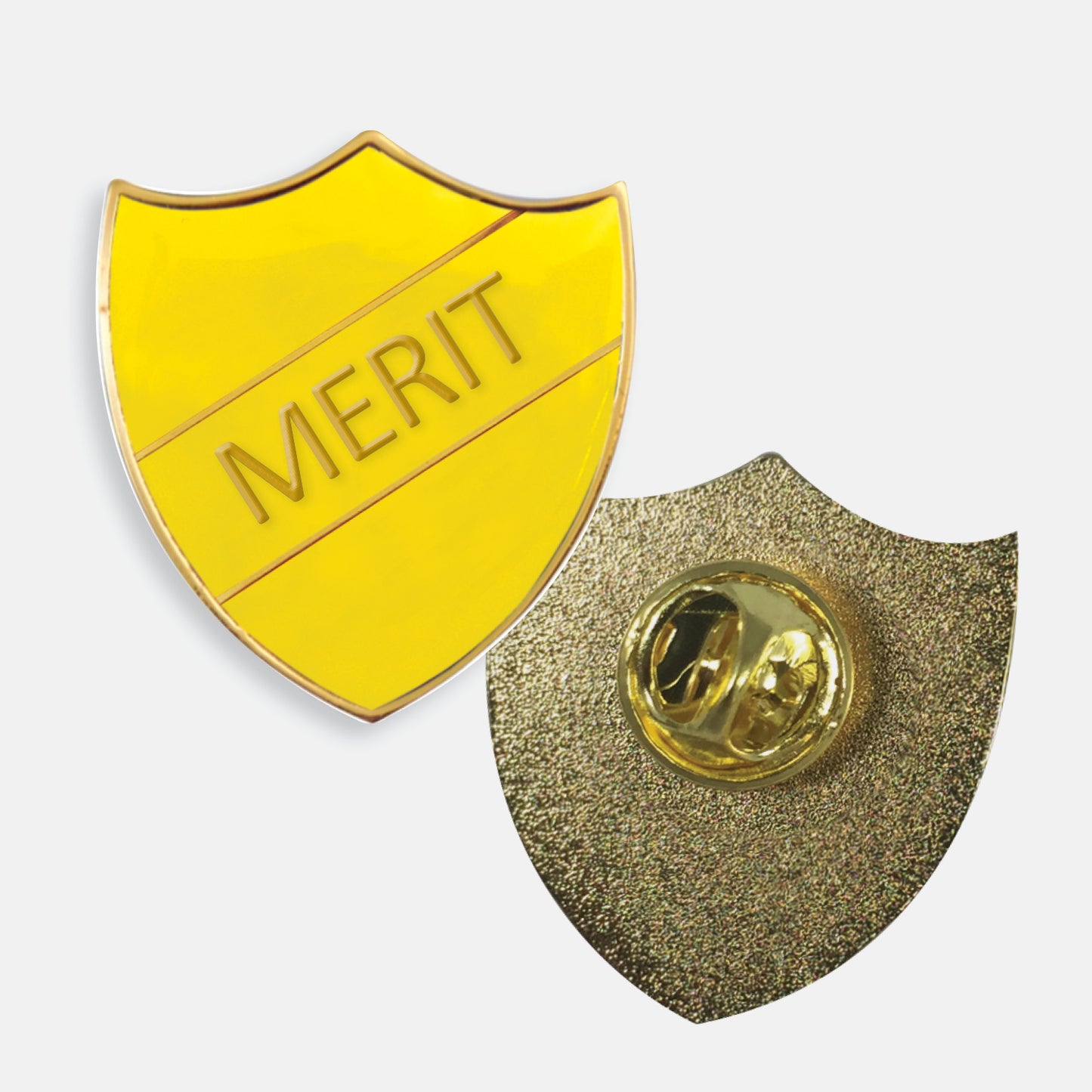 Yellow enamel badge in the shape of a shield with gold trim and diagonal gold line either side of the word 'MERIT' in capital letters. The reverse side shows a textured gold back with a pin fastening