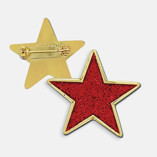 Red glittery enamel badge in the shape of a star with gold trim. The reverse side shows a gold back with a pin fastening