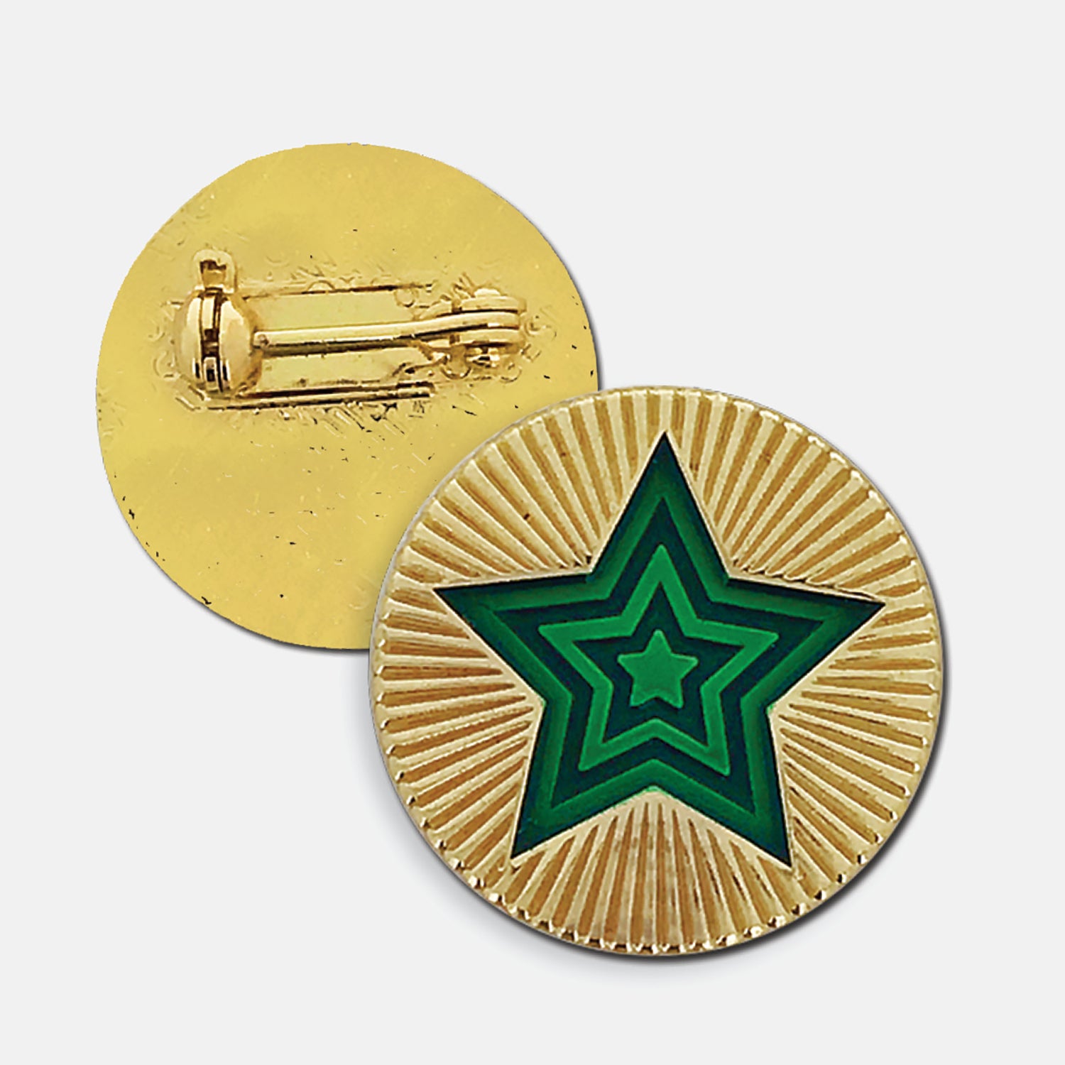 Gold enamel round badge with a radiating green star in the centre, the gold enamel surrounding the star is engraved to depict a starburst. The reverse side shows a gold back with a pin fastening.