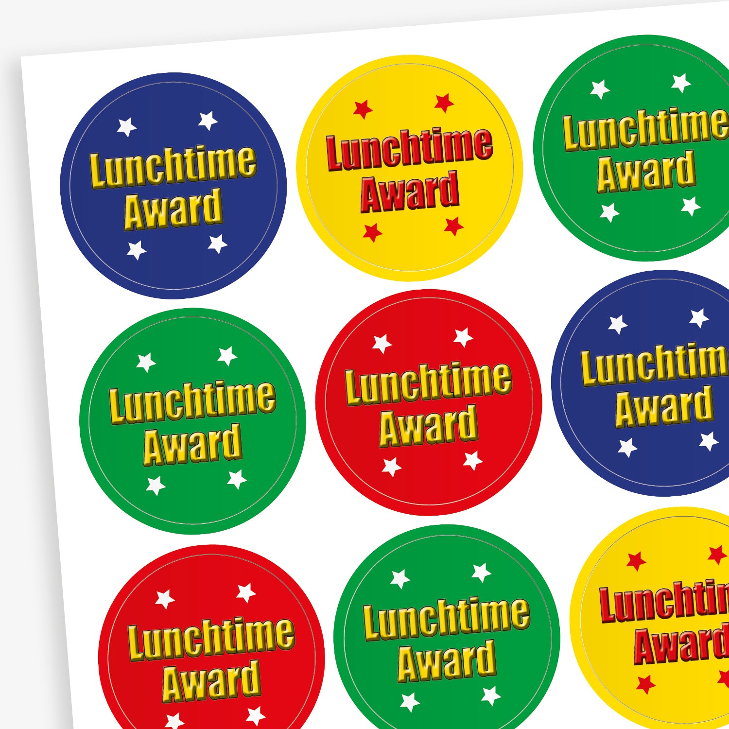 A sheet of circular reward stickers in various bright colours, each featuring the text 'Lunchtime Award' in bold yellow lettering. The stickers come in red, green, blue, and yellow backgrounds, with some including small white or coloured stars around the text.