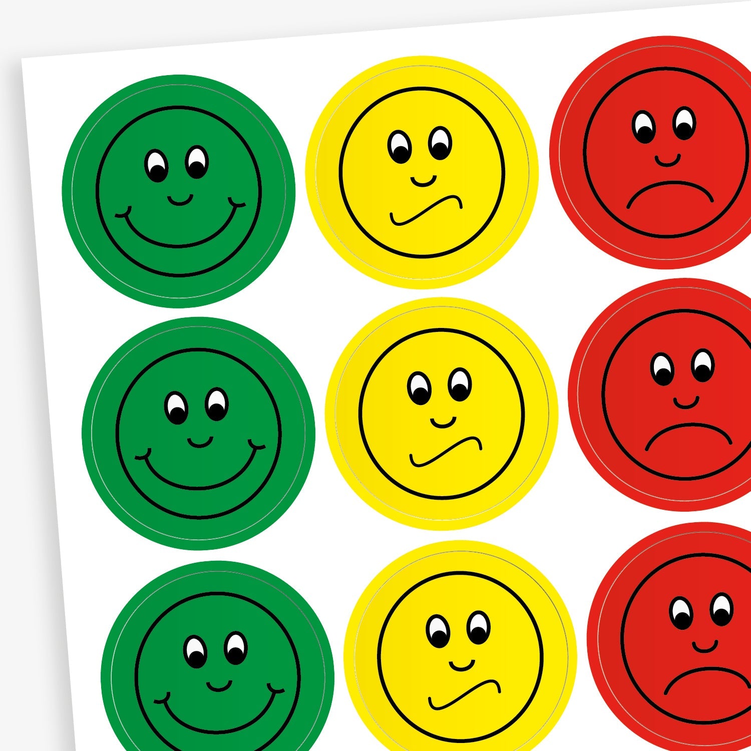 A sheet of stickers representing behaviour with a green sticker with a smiling face, a yellow sticker with an unsure face and a red sticker with a sad face.