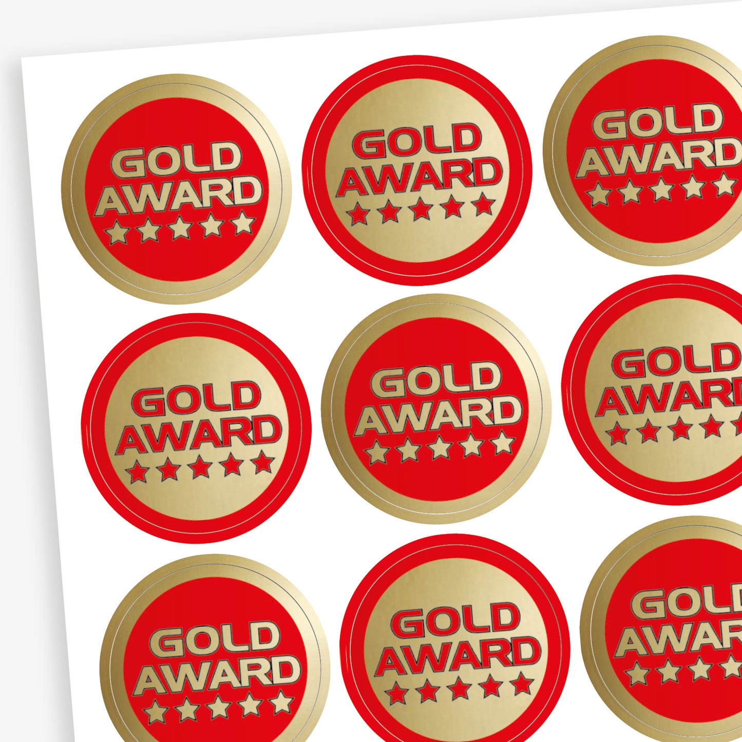 Sheet of 70, 25mm circular stickers with a metallic gold finish; each sticker features the text 'GOLD AWARD' above 5 stars.  The sheet has 50% stickers with a gold base and red text, and 50% a red base with gold text.
