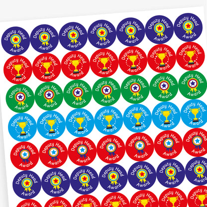 Overview of a sheet of circular 'Deputy Head Award' stickers in three colour variations: blue with a rosette, red with a gold trophy and stars, and green with a rosette. Each sticker features white text and celebratory imagery indicating achievement.