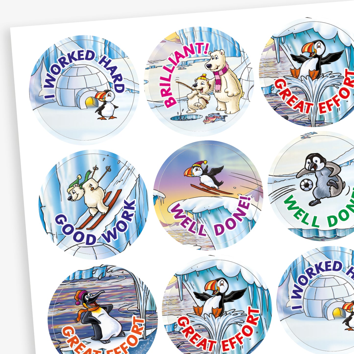 A sheet of circular reward stickers with phrases including 'I worked hard', 'Good Work', 'Well done' and 'Great Effort' in colourful text. Each sticker features arctic-themed cartoon animals such as puffins, polar bears, and walruses, engaging in playful activities against icy, snowy backdrops. 