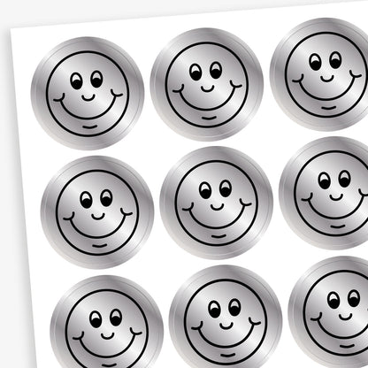 A sheet of metallic silver stickers each with a smiling face as a black outline as it's design