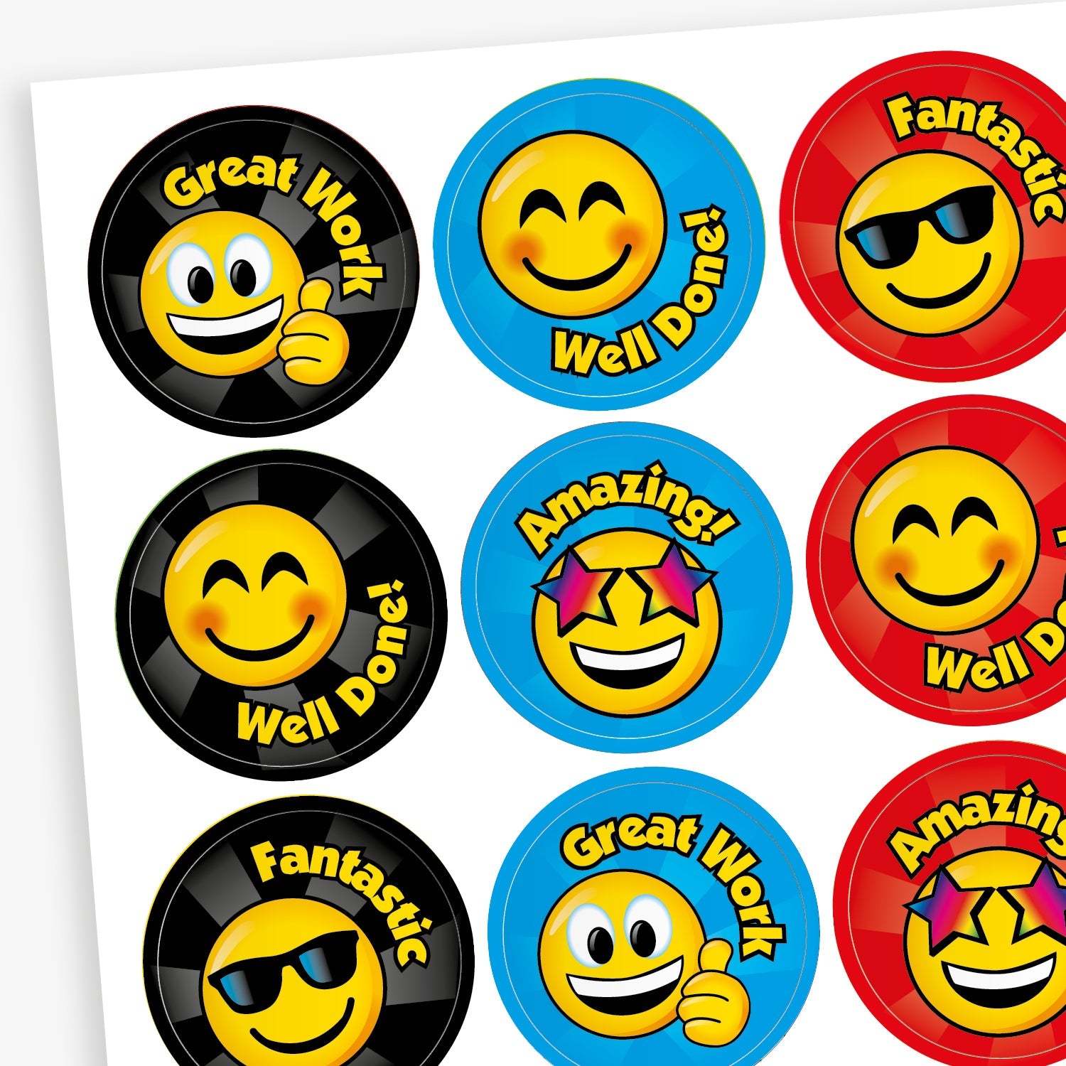 A sheet of colourful reward stickers featuring cheerful smiley faces with different expressions. Each circular sticker includes praise such as 'Great Work', 'Well Done!', 'Fantastic', and 'Amazing!'. The backgrounds are in bright colours like black, blue, and red, with each smiley wearing accessories like sunglasses or stars, designed to celebrate effort and achievement.