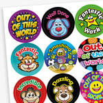 Sheet of colourful reward stickers with fun cartoon characters and praise words such as 'Out of this World', 'Well Done', 'Fantastic Work', 'Smashing', 'Incredible', and 'Dazzling'. Designs include animals, stars, robots, and smiley faces