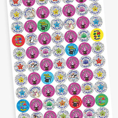 A sheet of holographic colourful round stickers with maths-themed praise. Including a pink sticker with a rabbit in a magician's hat and the phrase 'Magical Maths', a yellow sticker with maths symbols and the words 'Great Maths', a red sticker with a magician’s hat and the phrase 'Magic Maths', and a silver sticker with a smiling star and the phrase 'I am a Maths Star'.