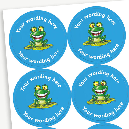 A sheet of customisable circular stickers featuring a cartoon frog on a lily pad against a blue background; includes customisable text above and below the image.