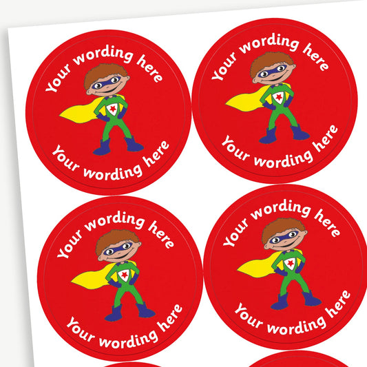 A sheet of red stickers featuring a boy superhero in a cape in the centre.  Placeholder text 'Your wording here' is above and below the image for customisation.