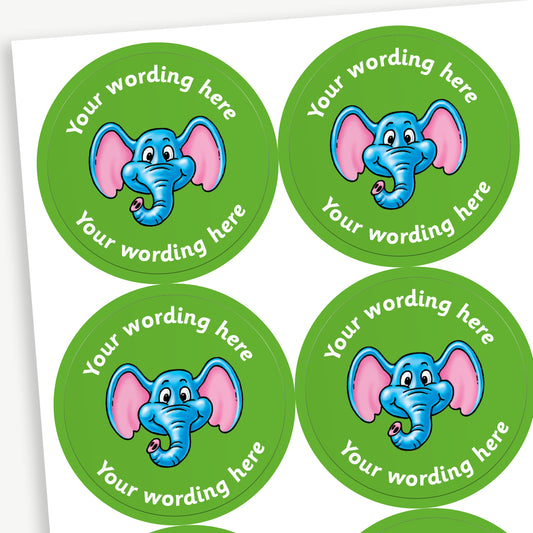 Sheet of round green stickers featuring an elephants head in the centre. Each sticker has placeholder text reading 'Your wording here' curved above and below the illustration for customisation.