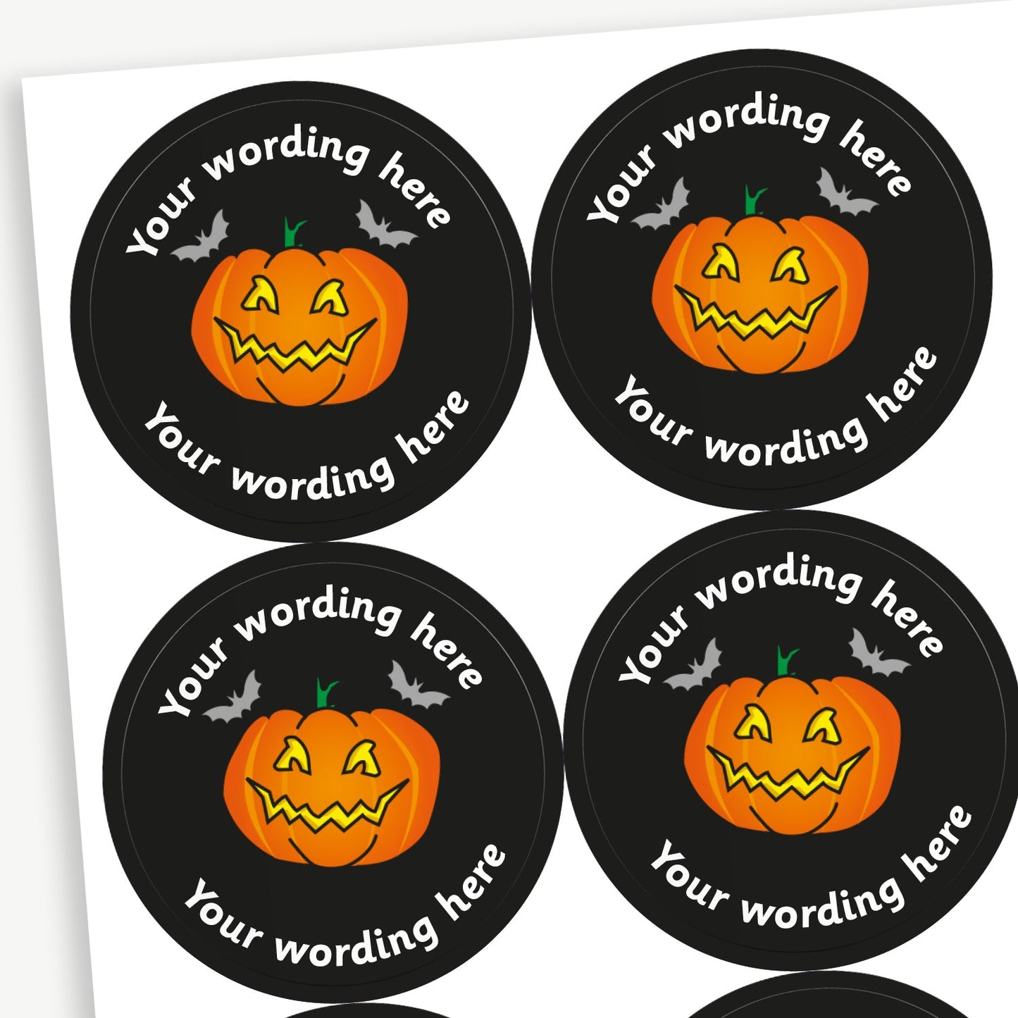 A sheet of customisable circular stickers featuring a carved pumpkin against a black background; includes customisable text above and below the image.