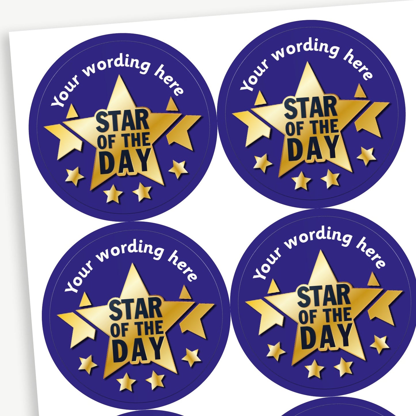 A sheet of round dark blue stickers, each featuring a large golden star with the text 'Star of the Day' in bold black letters with four smaller gold stars beneath and two behind. The top arc of each sticker has placeholder text 'Your wording here' for customisation.