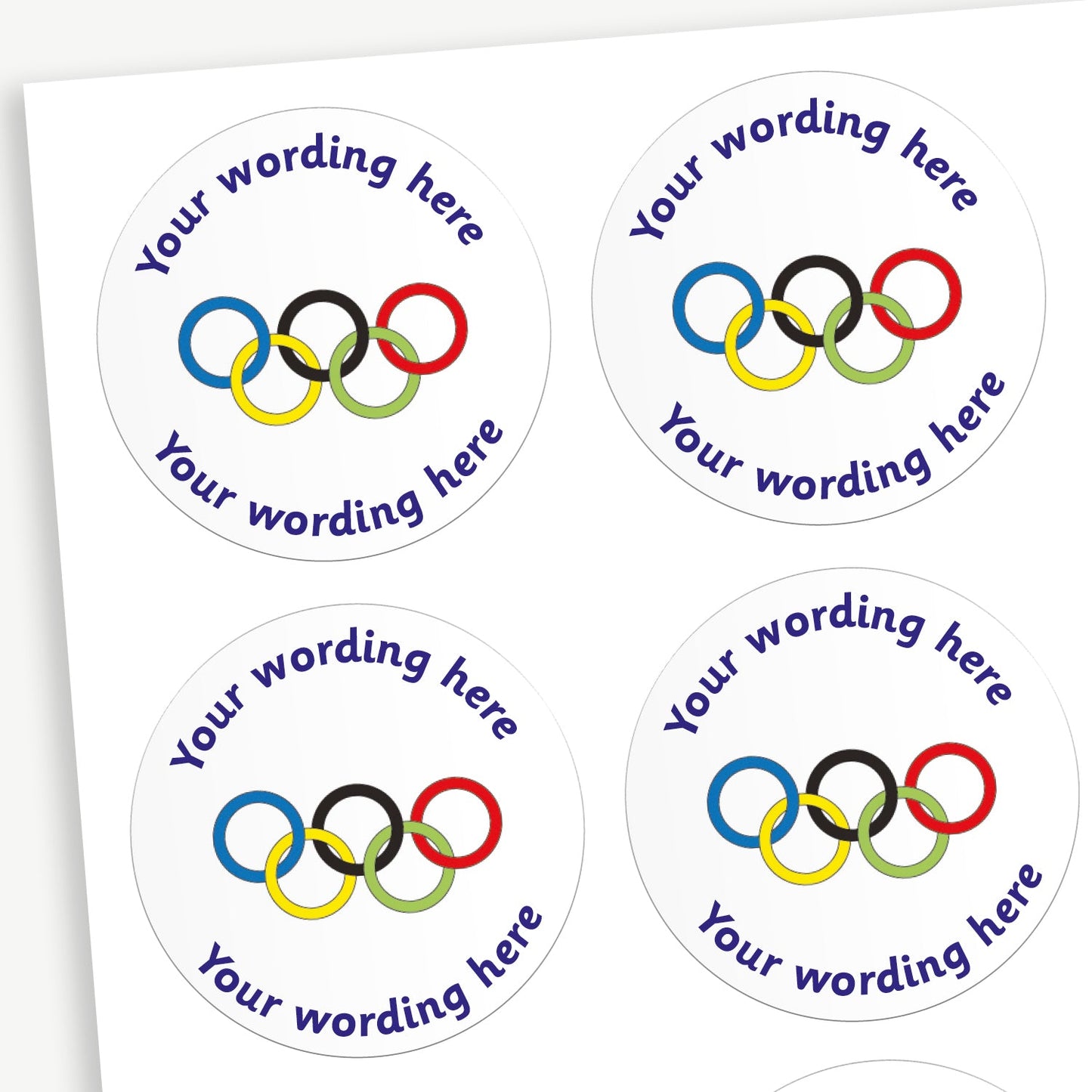 A sheet of white stickers featuring a olympic rings in the centre.  Placeholder text 'Your wording here' is above and below the image for customisation.