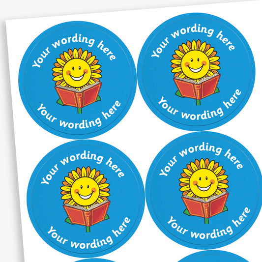 A sheet of blue stickers featuring a smiling sunflower reading a book in the centre.  Placeholder text 'Your wording here' is above and below the image for customisation.