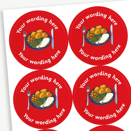 A sheet of circular reward stickers with a red background, each featuring a colourful illustration of a dinner plate with vegetables, potatoes with knife and fork. There is customisable text 'Your wording here' written in white above and below the image. 