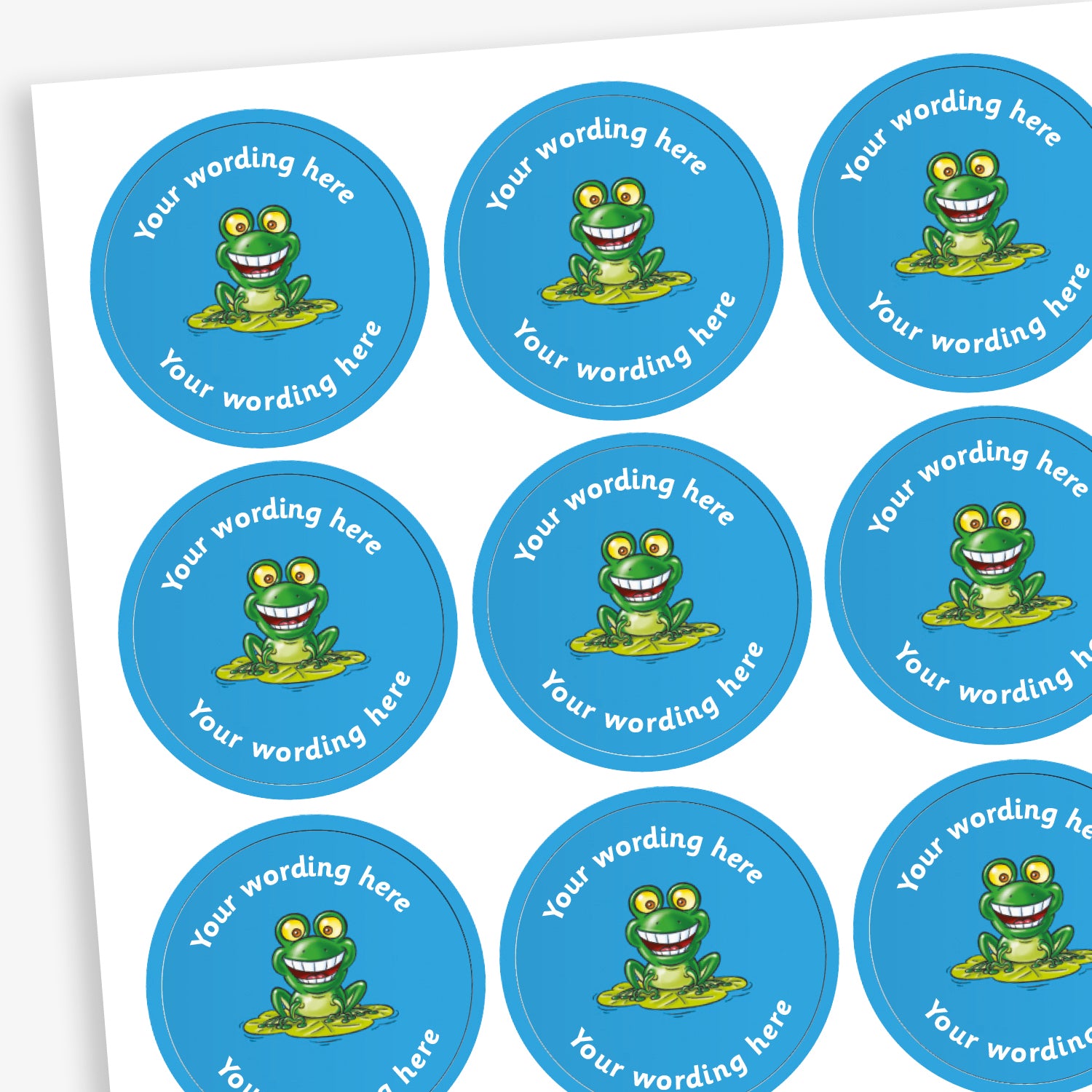 A sheet of circular, blue reward stickers featuring acartoon frog on a lily pad in the centre. Placeholder text above and below 'Your wording here' indicate customisation options.