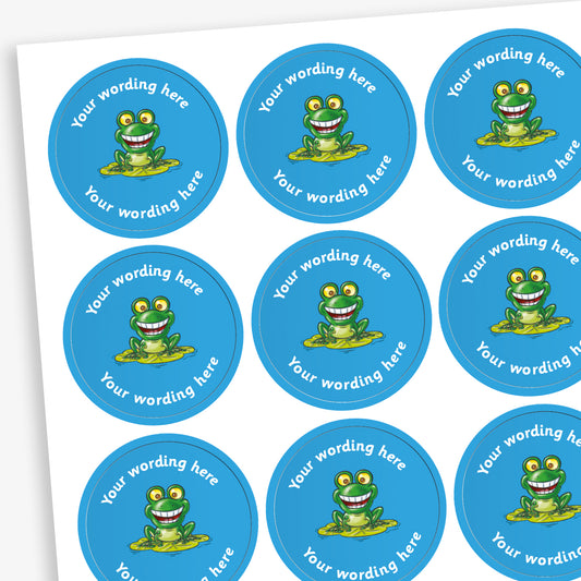 A sheet of circular, blue reward stickers featuring acartoon frog on a lily pad in the centre. Placeholder text above and below 'Your wording here' indicate customisation options.