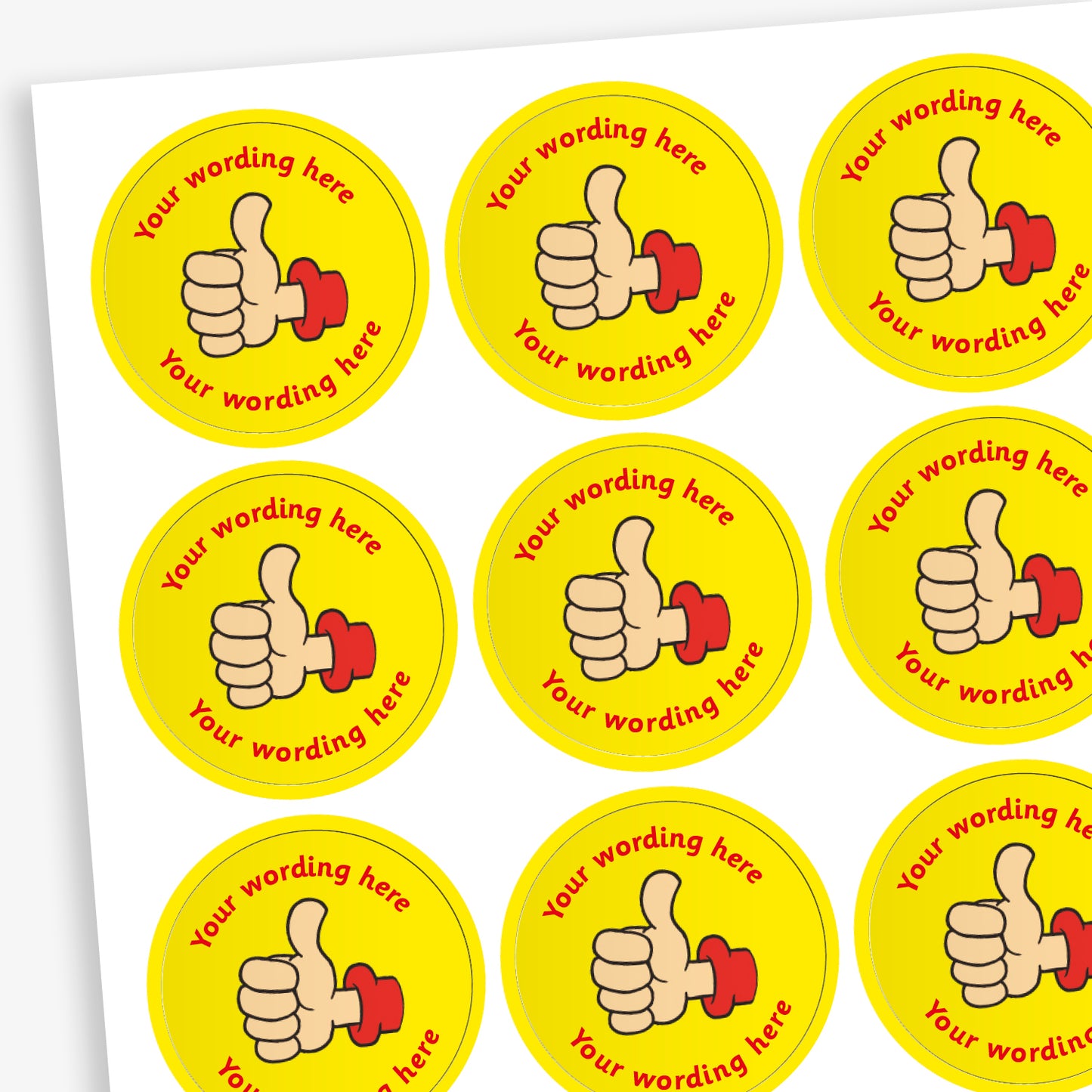 A sheet of circular, yellow reward stickers featuring a hand with a thumbs up. Placeholder text above and below 'Your wording here' indicate customisation options.
