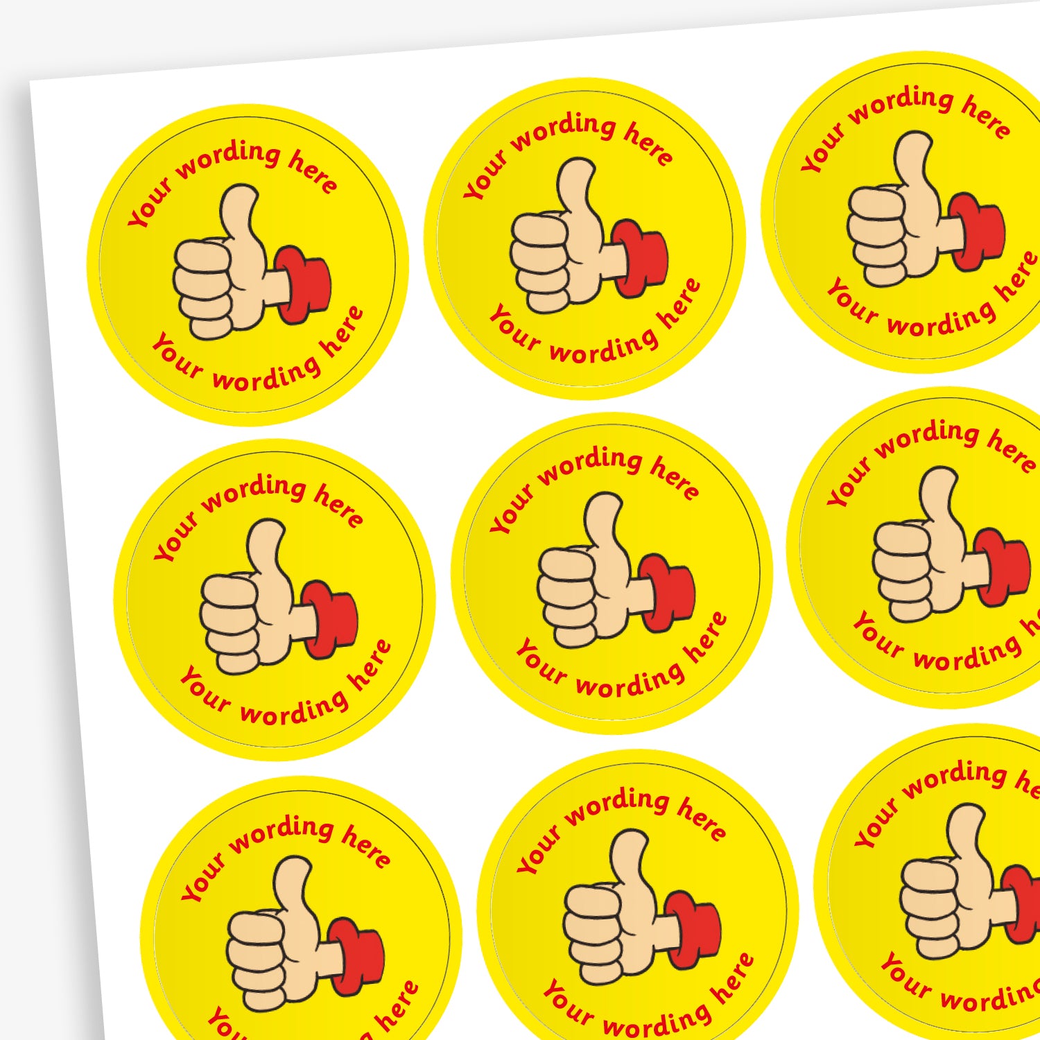 A sheet of circular, yellow reward stickers featuring a hand with a thumbs up. Placeholder text above and below 'Your wording here' indicate customisation options.