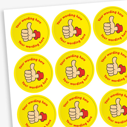A sheet of circular, yellow reward stickers featuring a hand with a thumbs up. Placeholder text above and below 'Your wording here' indicate customisation options.