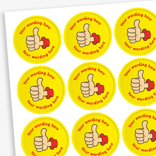 A sheet of circular, yellow reward stickers featuring a hand with a thumbs up. Placeholder text above and below 'Your wording here' indicate customisation options.