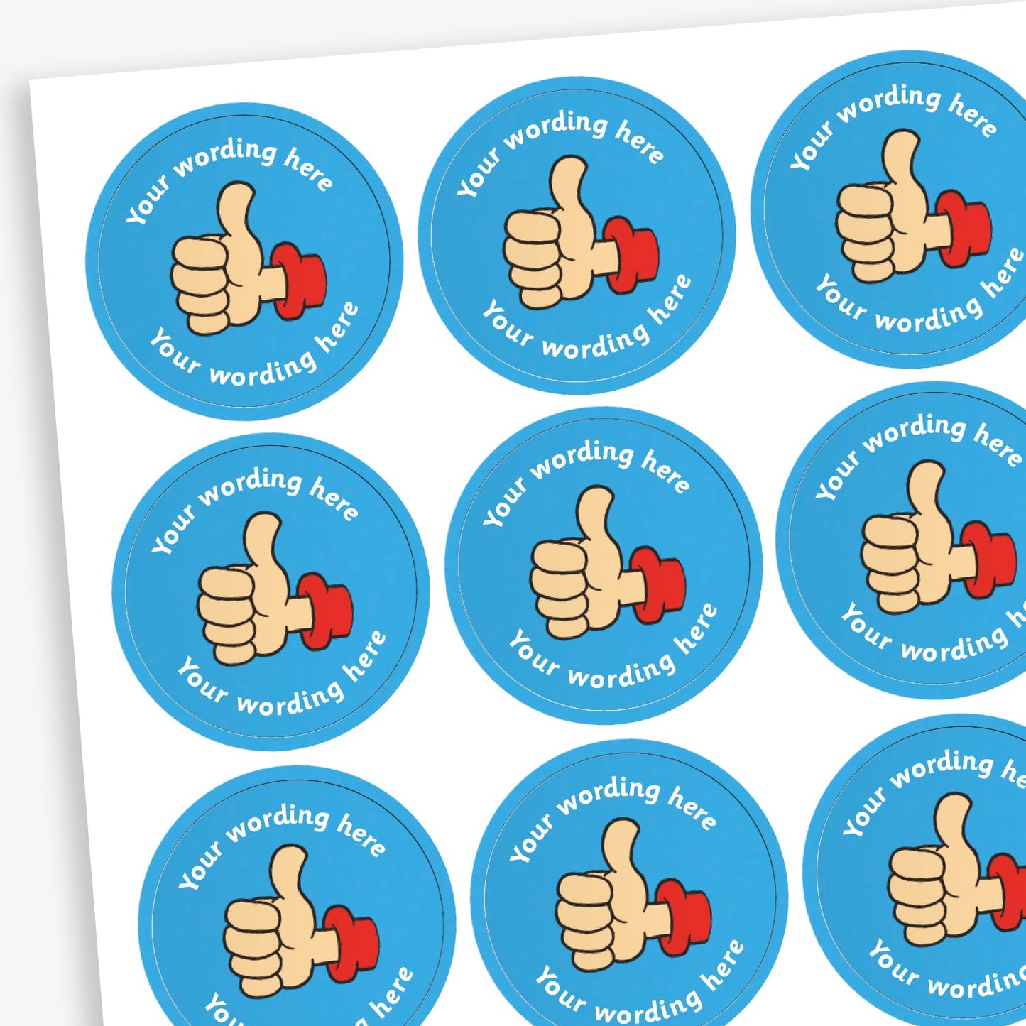 A sheet of circular, blue reward stickers featuring a hand with a thumbs up. Placeholder text above and below 'Your wording here' indicate customisation options.
