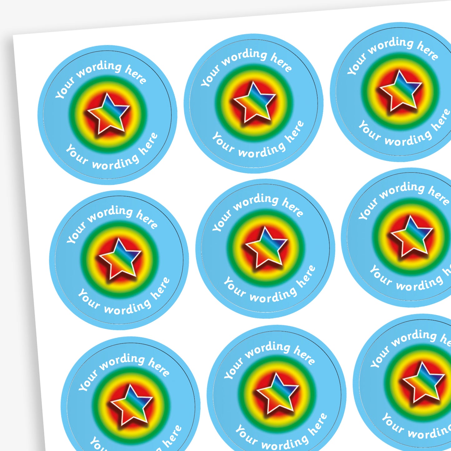 A sheet of personalised rainbow star stickers with space for custom text, featuring a colourful star in the centre of each blue circular sticker.