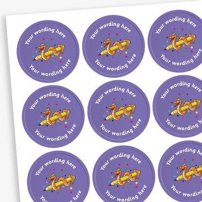 Sheet of purple, circular stickers.  There is a yellow pencil illustration with a smiling orange snake wrapped around it as a central image amongst a shower of multicoloured stars.  Placeholder text above and below 'Your wording here' indicate customisation options.
