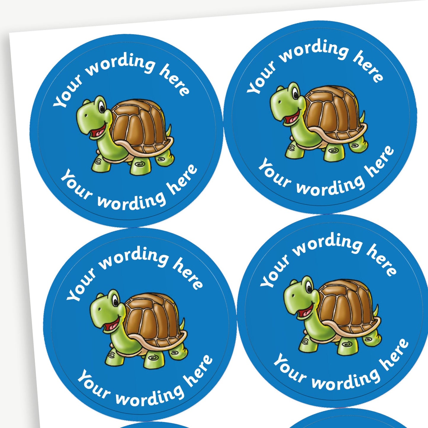 A sheet of blue circular stickers featuring a cartoon tortoise in the centre; curving above and below the image is space for personalisation 'Your wording here' in a clear, bold font.